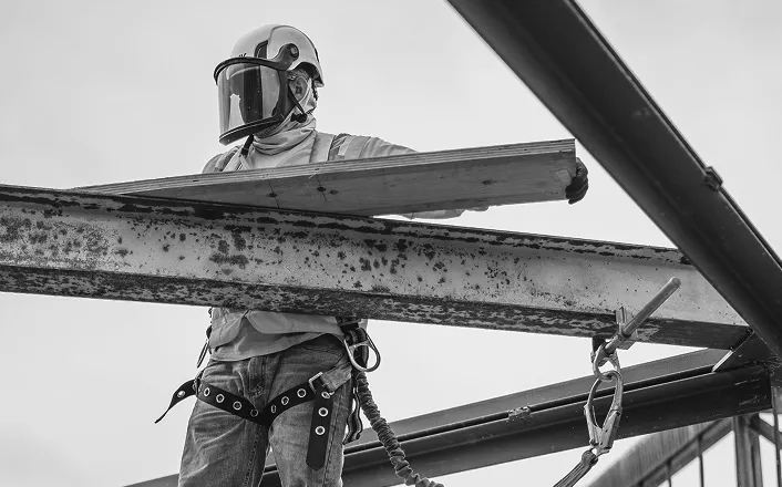Construction worker wearing full safety gear on-site