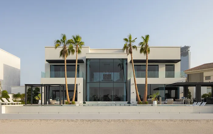 Spacious living room in a modern villa with modular sofas and floor-to-ceiling windows