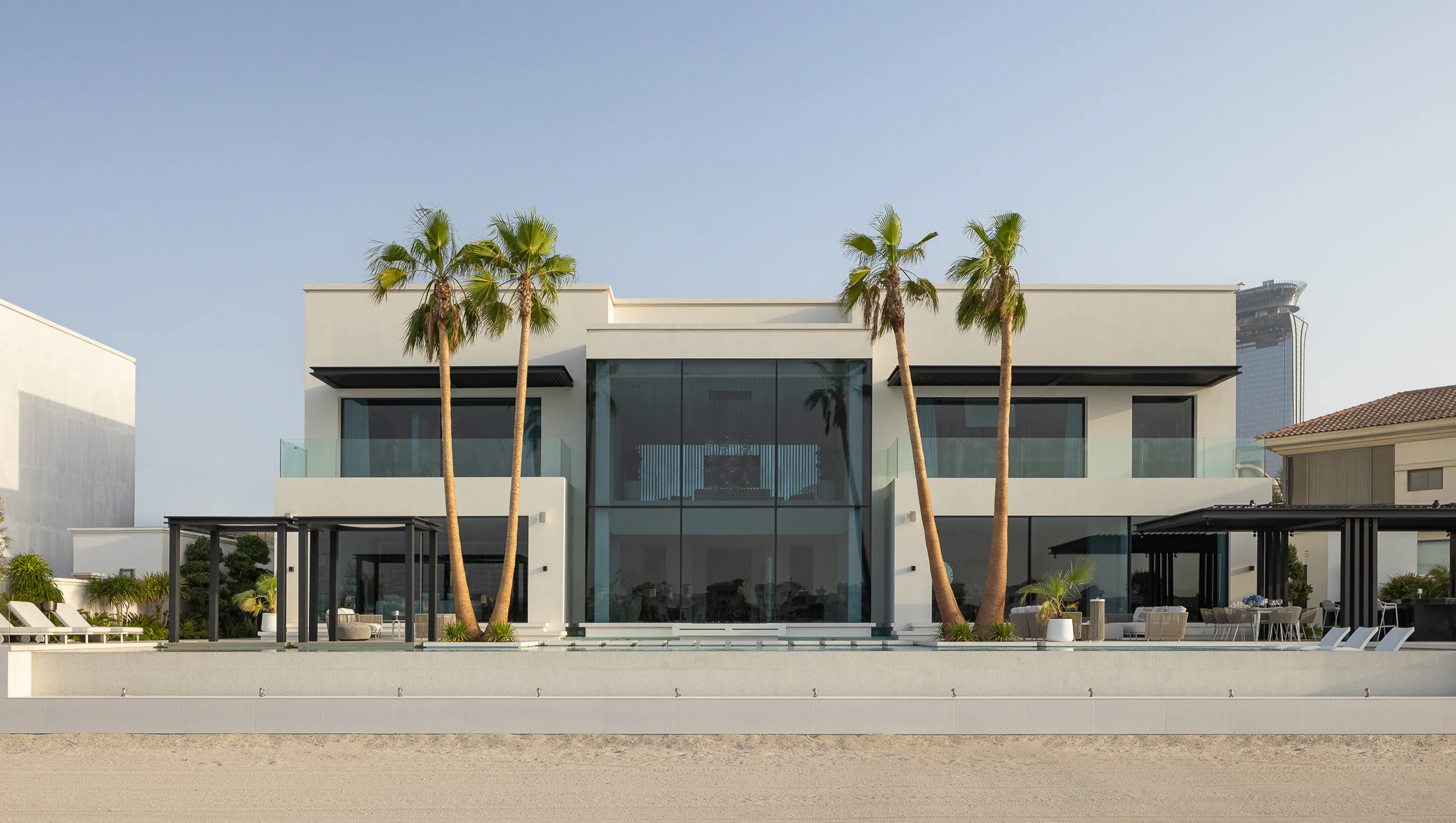 Spacious living room in a modern villa with modular sofas and floor-to-ceiling windows