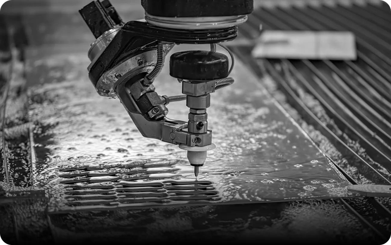 Waterjet cutting machine used for precise detailing in stone and metal elements.