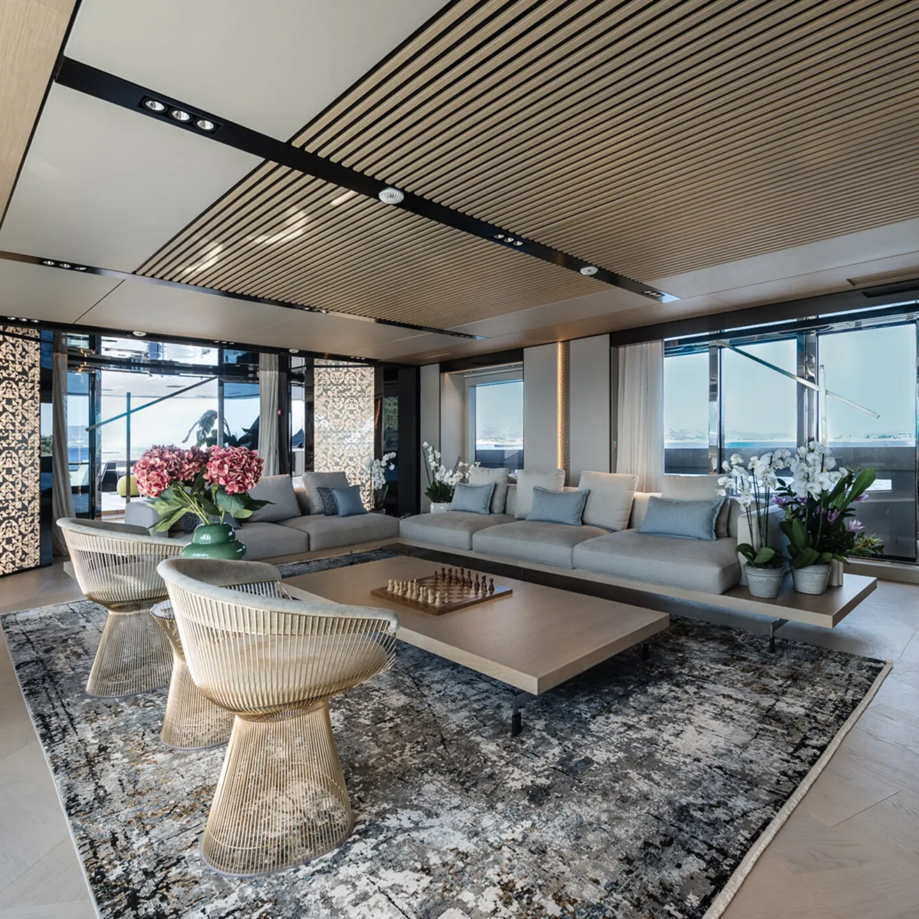 Luxury living room in yacht with bespoke handmade furniture, fixed sofas, and luxury detailing