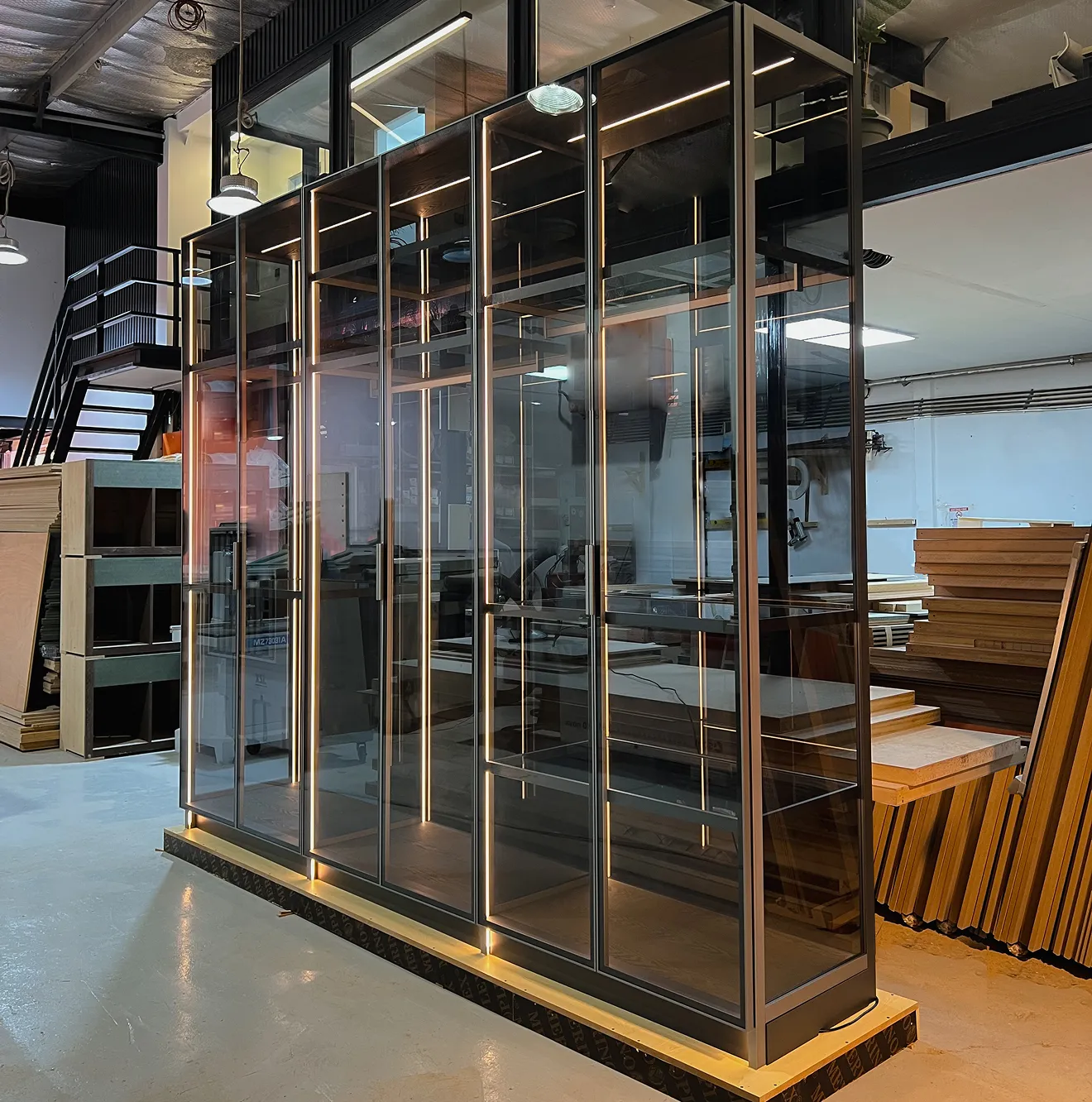 Custom walk in closet with multi-level shelves, hanging racks, and drawer systems