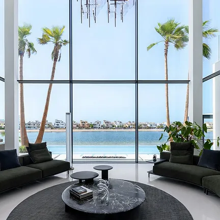 Modern villa interior design in Palm Jumeirah with floor to ceiling glass panels