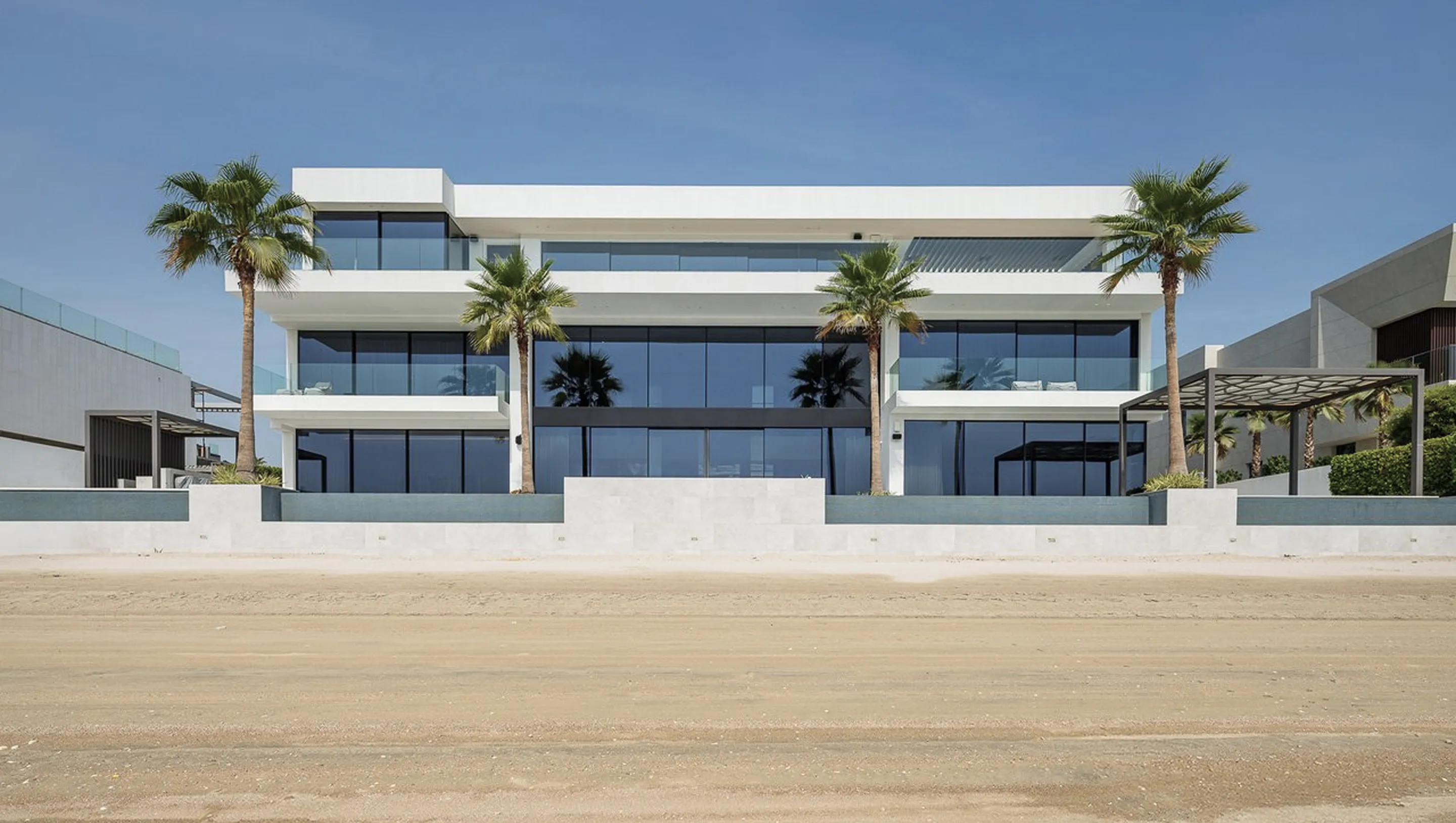 Luxury beachfront villa renovation in Palm Jumeirah with expansive glass