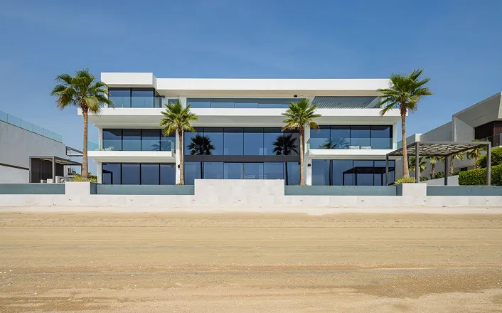 Luxury beachfront villa renovation in Palm Jumeirah with expansive glass