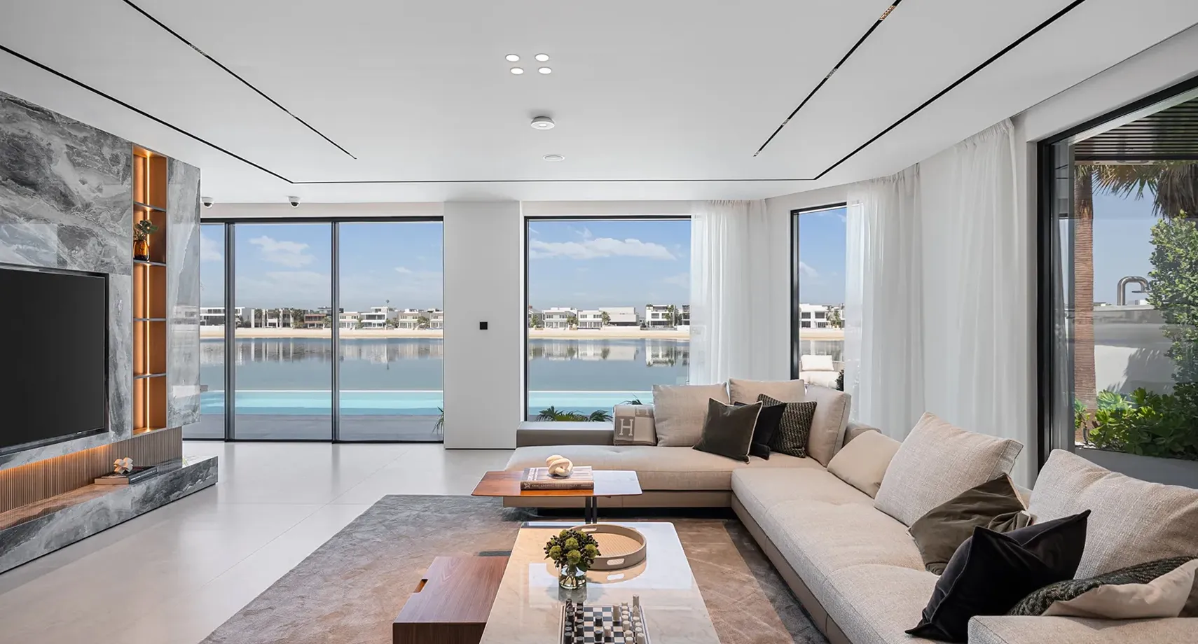 Modern renovated Palm Jumeirah villa living room with panoramic waterfront views