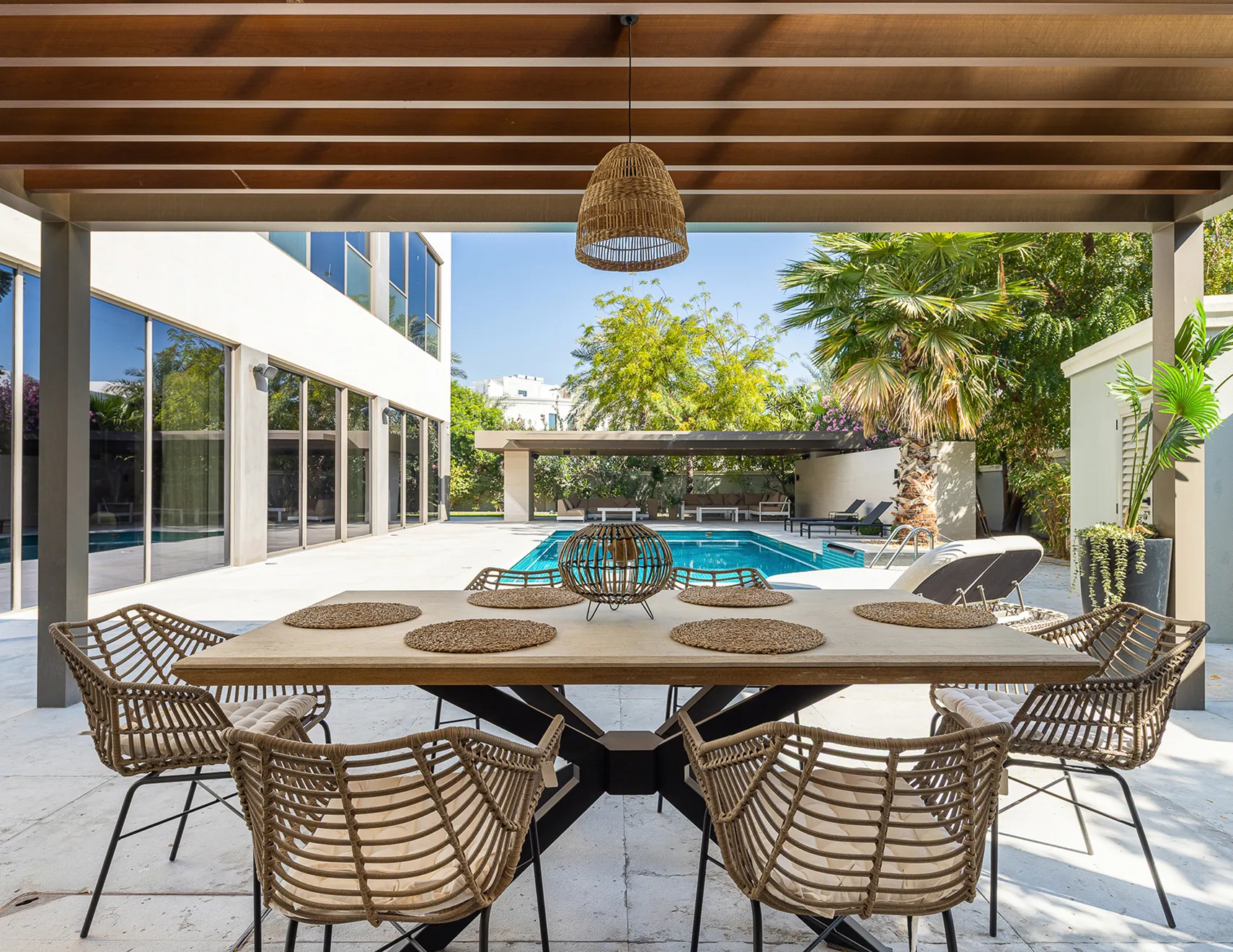 Outdoor area in a luxury villa featuring built in pool and custom designed pergola