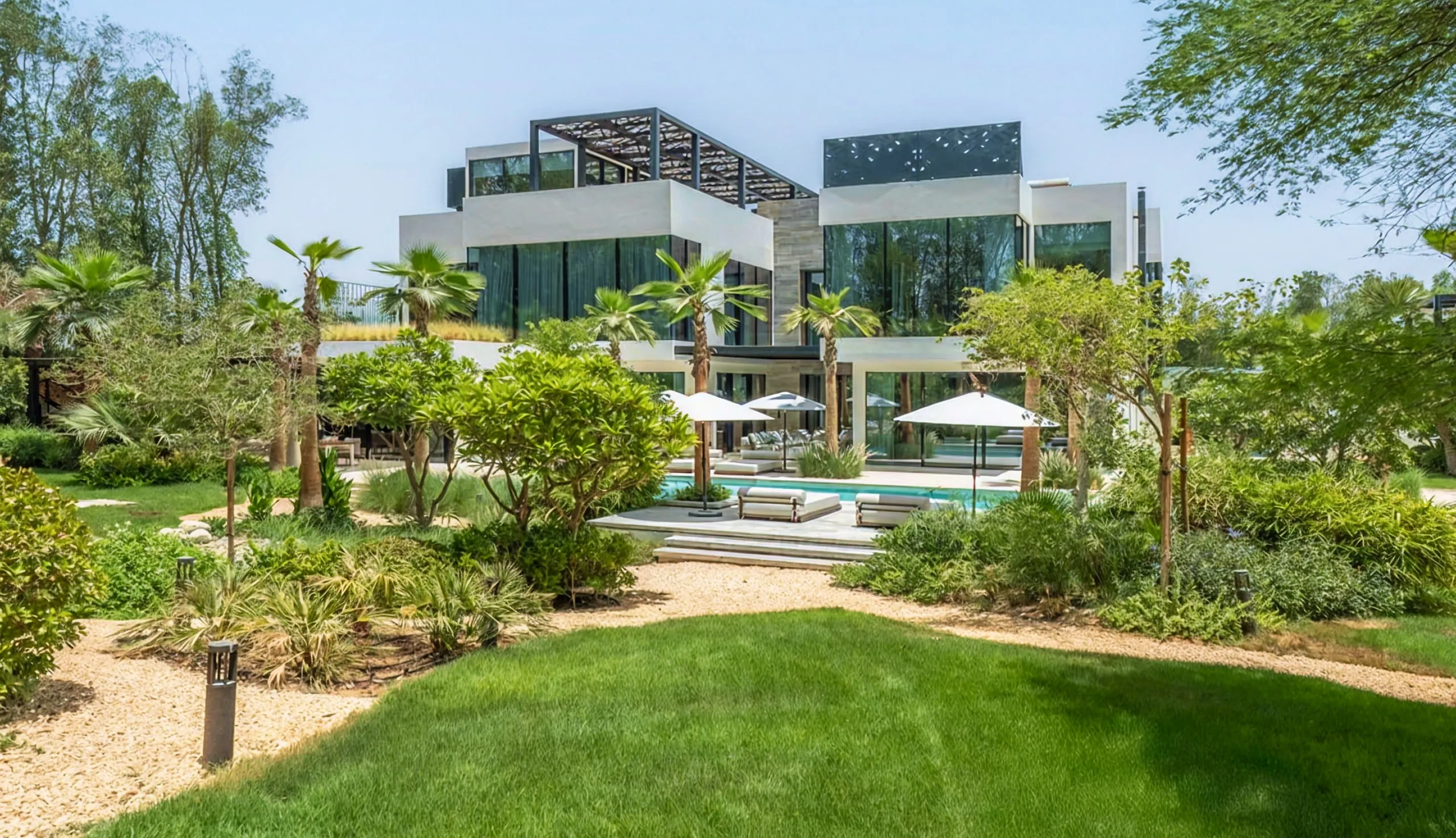 Luxury villa with a built-in pool and lush green landscaping in AL Barari