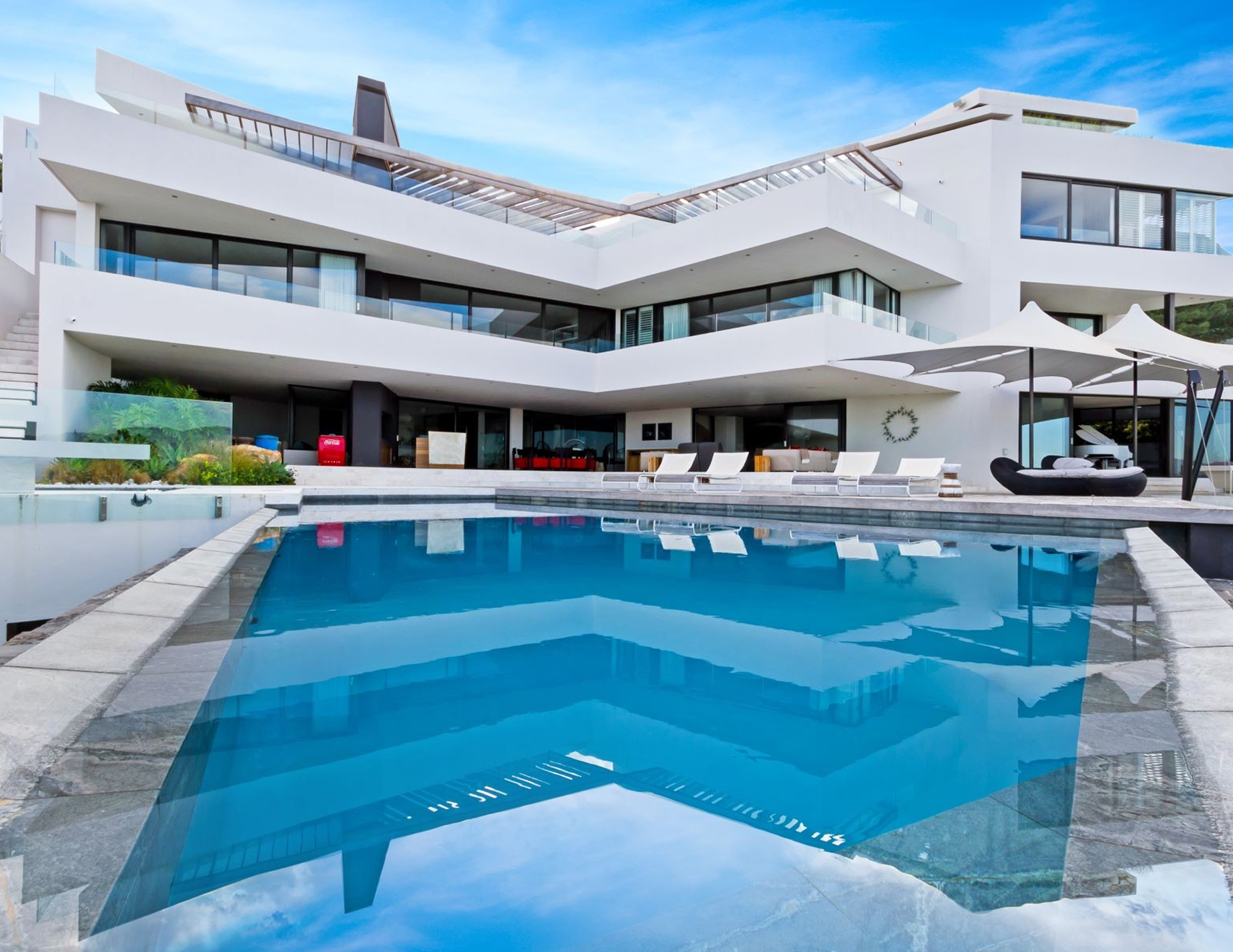 Luxury interior design in Kenya featuring a built-in infinity pool and a custom-designed lounge area in a private villa