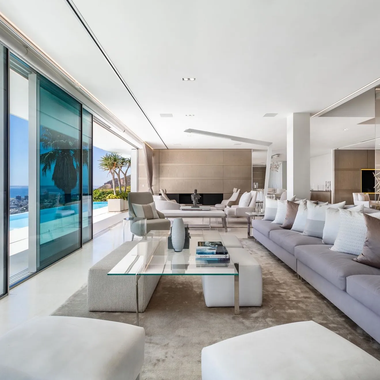 A modern luxury interior design with modular sofas and expansive sliding glass doors