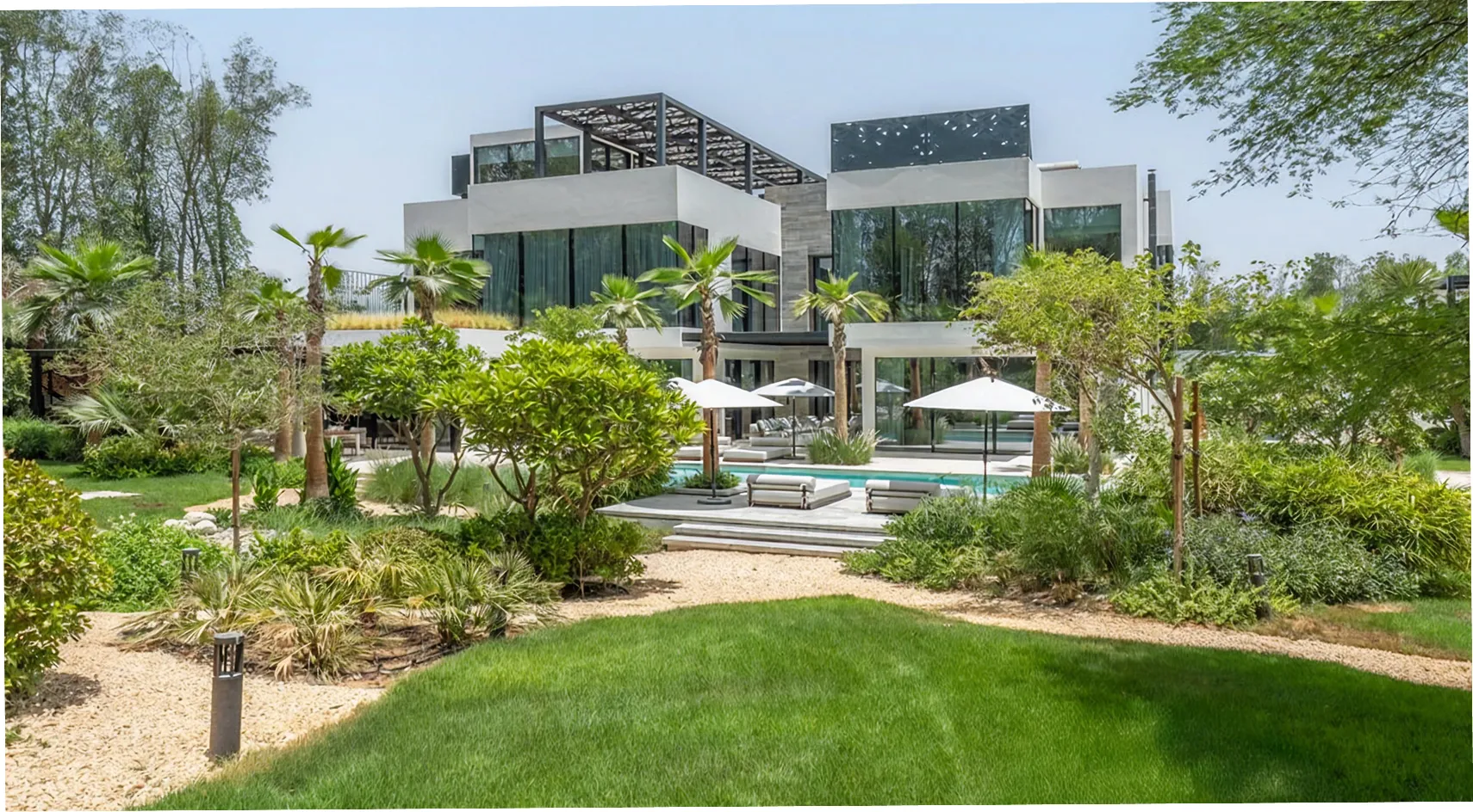 Luxury villa featuring lush green landscaping