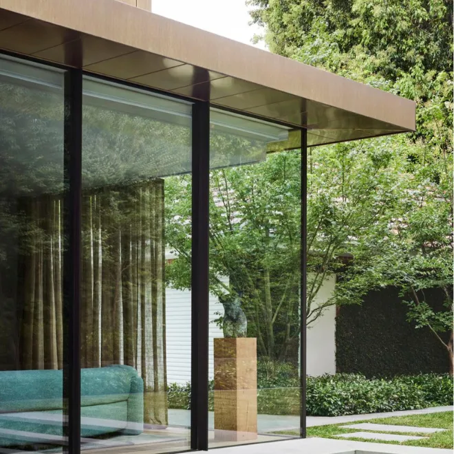 Modern desert home interior featuring bulletproof glass windows that create a secure connection with the natural landscape