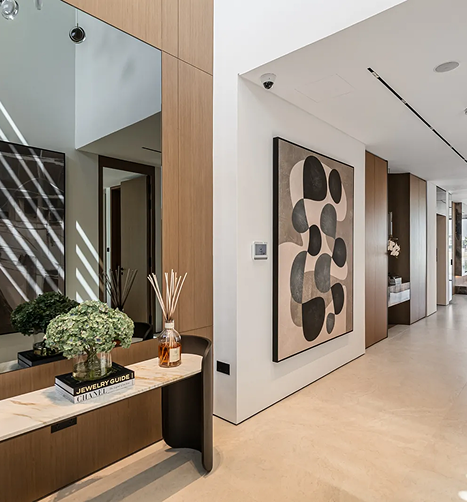 Contemporary bedroom interior with wood paneling, a low-profile bed, and integrated lighting
