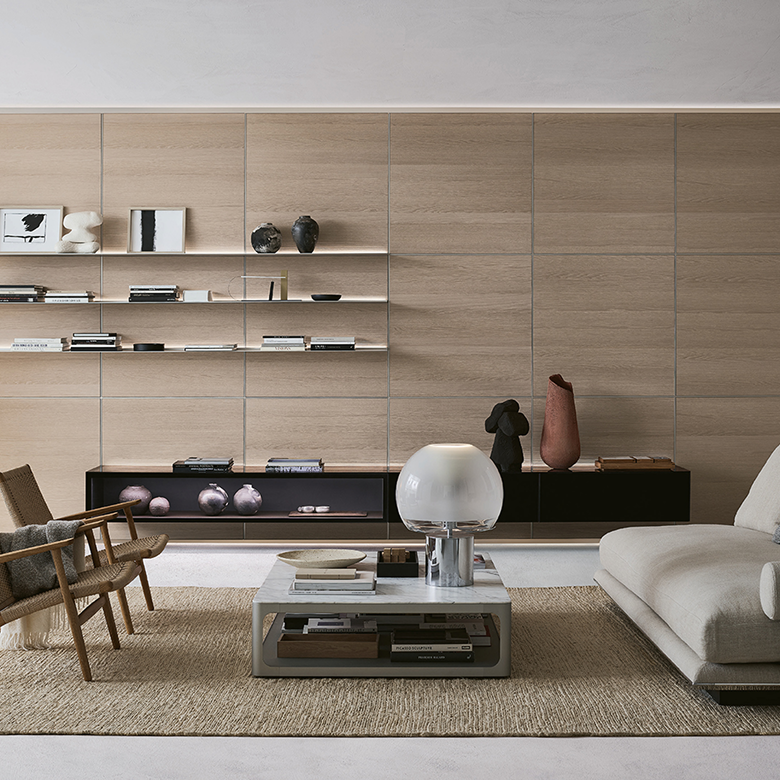Modern living room interior with a Minotti Twiggy sofa, armchairs, and a dark coffee table