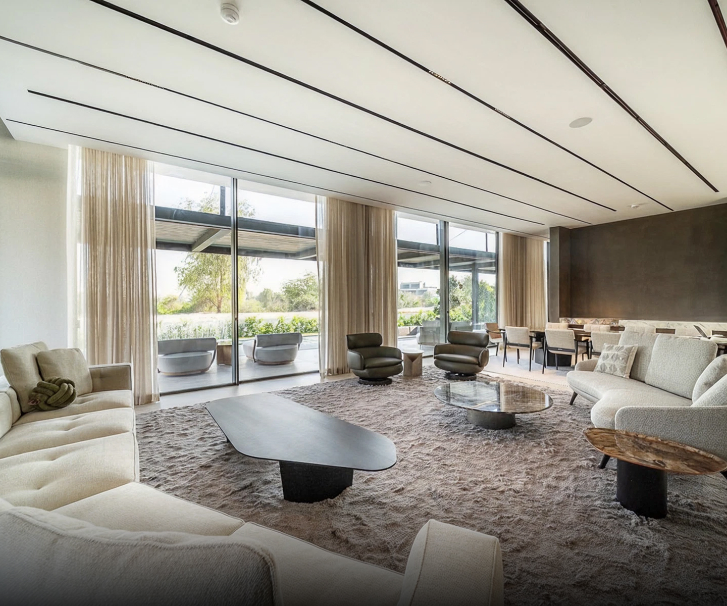 Modern living room interior design with a floating glass staircase in Dubai.