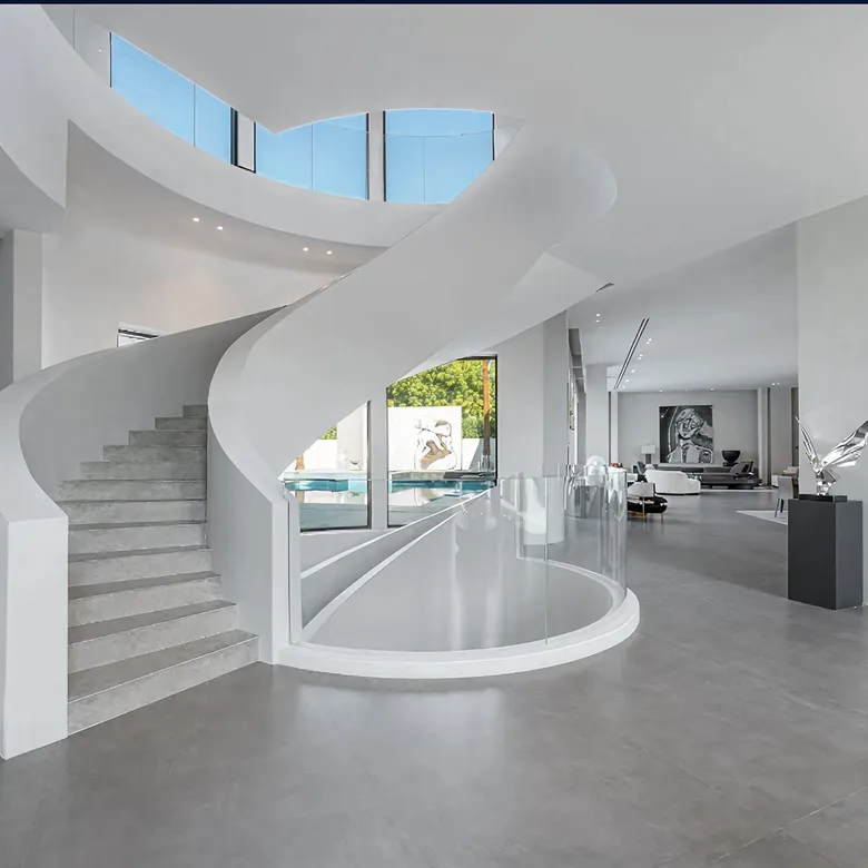 Villa interior design in Abu Dhabi featuring a modern staircase and poolside view.