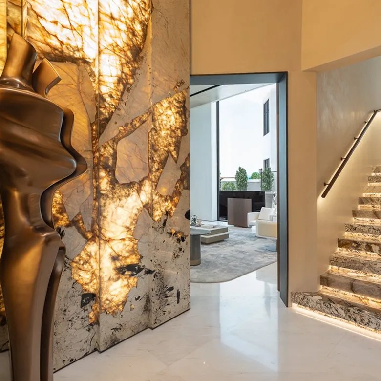 Luxury villa hallway in Abu Dhabi featuring contemporary interior design featuring an illuminated staircase.