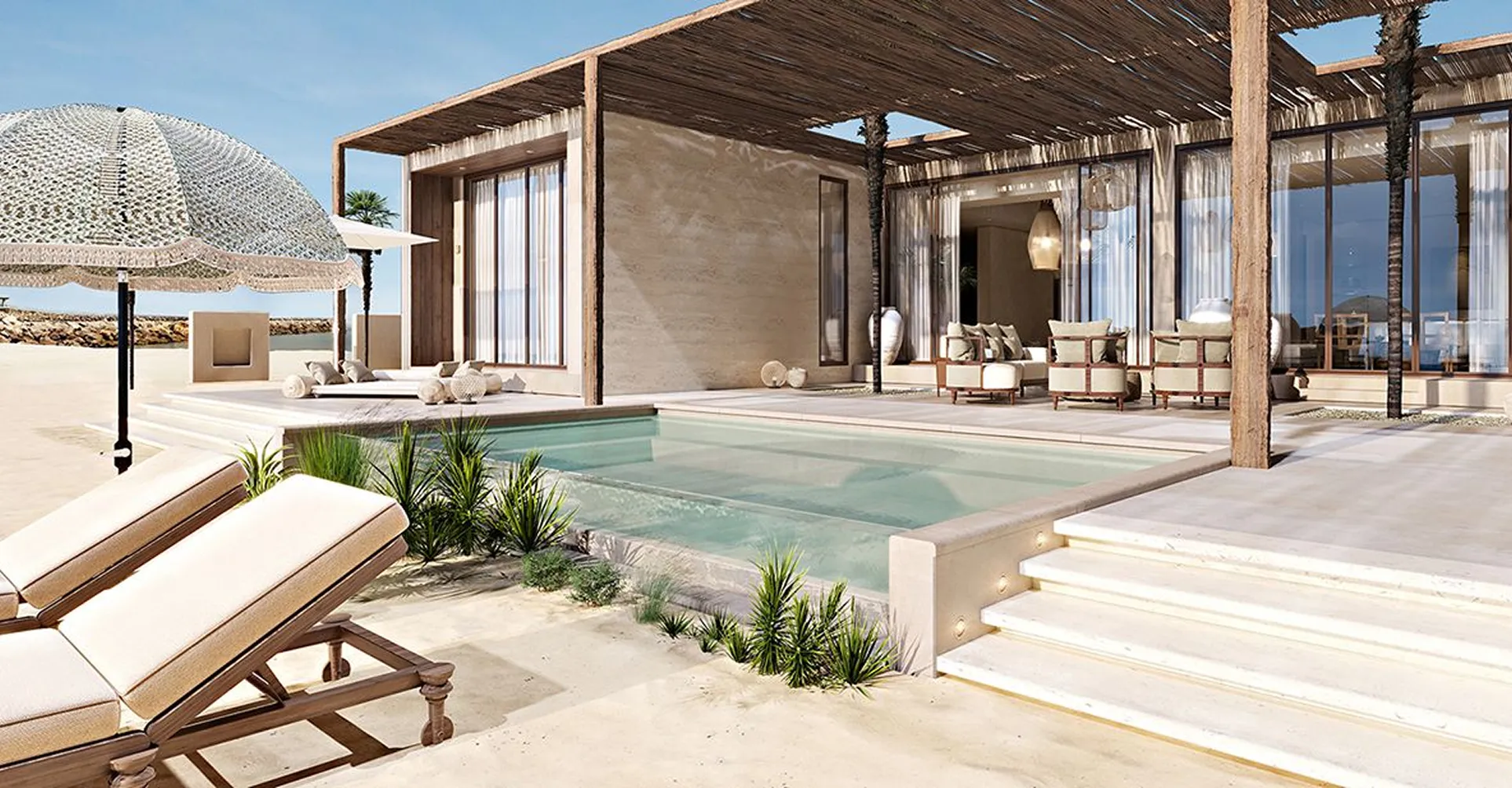 Beachfront resort suite featuring a private pool and modern interior design.