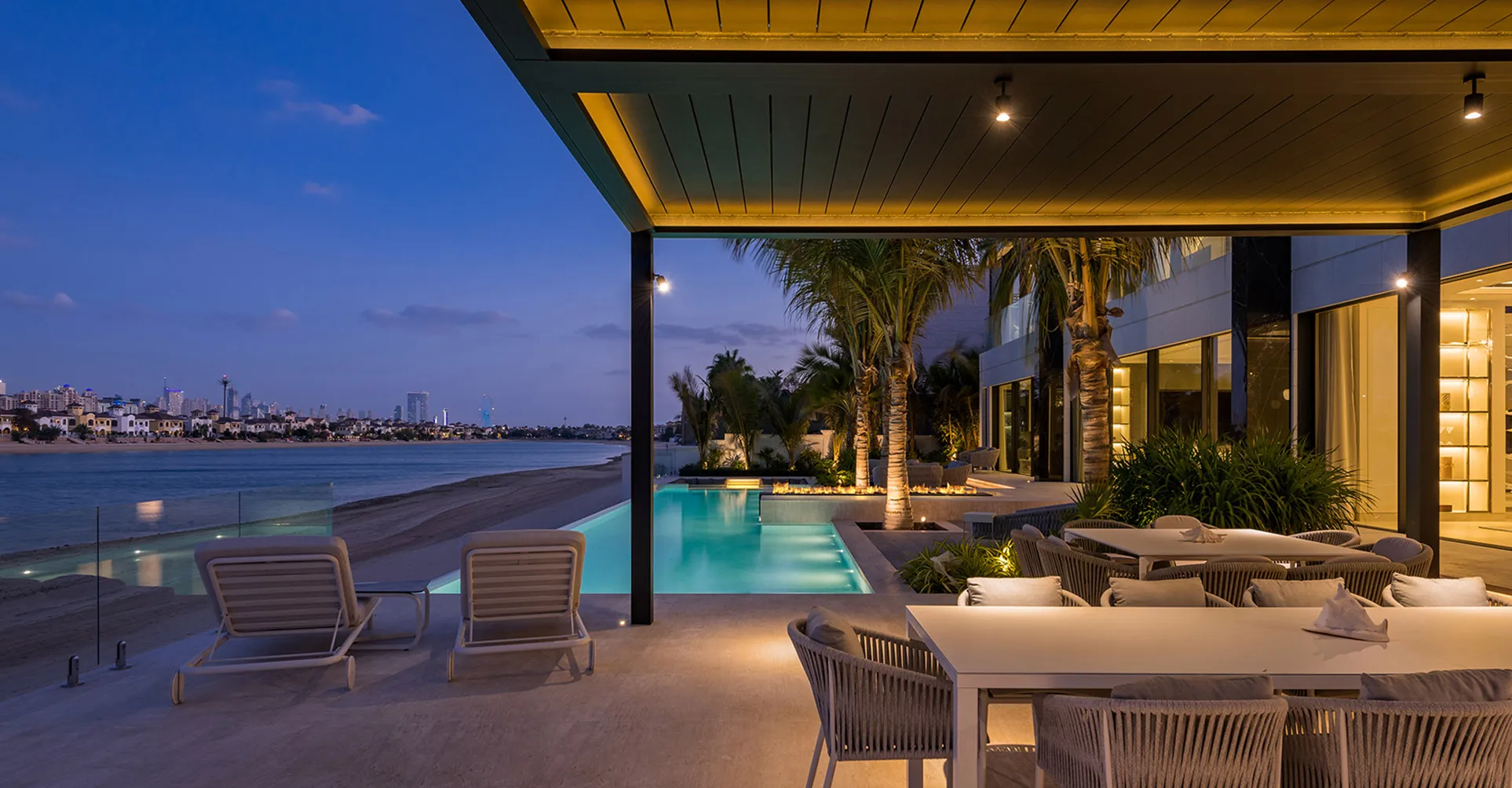 Outdoor space in a modern villa featuring a built-in pool and pergola in Dubai.