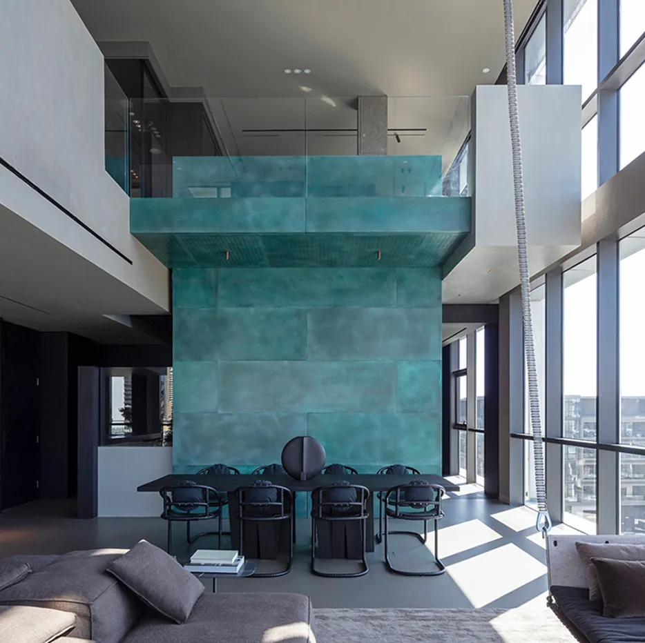 Architectural interior with wood-paneled hallway, glass partitions, and warm lighting by Rayfitout.