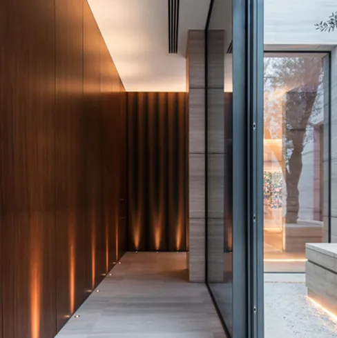 Luxury bedroom interior design with wood-paneled walls and LED ceiling lighting.