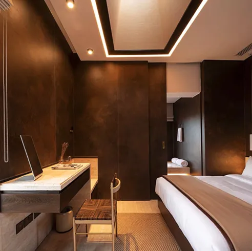 Modern rooftop swimming pool with stone steps featuring bespoke interior design.