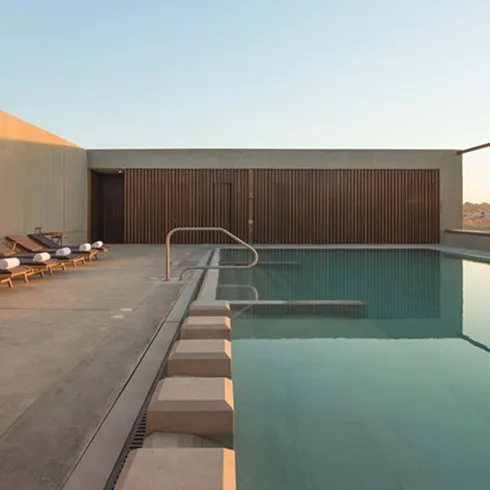 Luxury villa with minimalist interior design in a desert landscape.