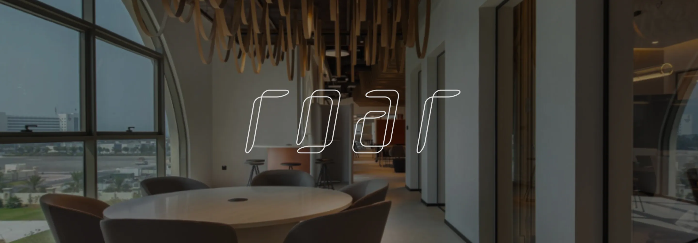 Modern interior with sculptural tree centerpiece and illuminated wooden shelving by Rayfitout.