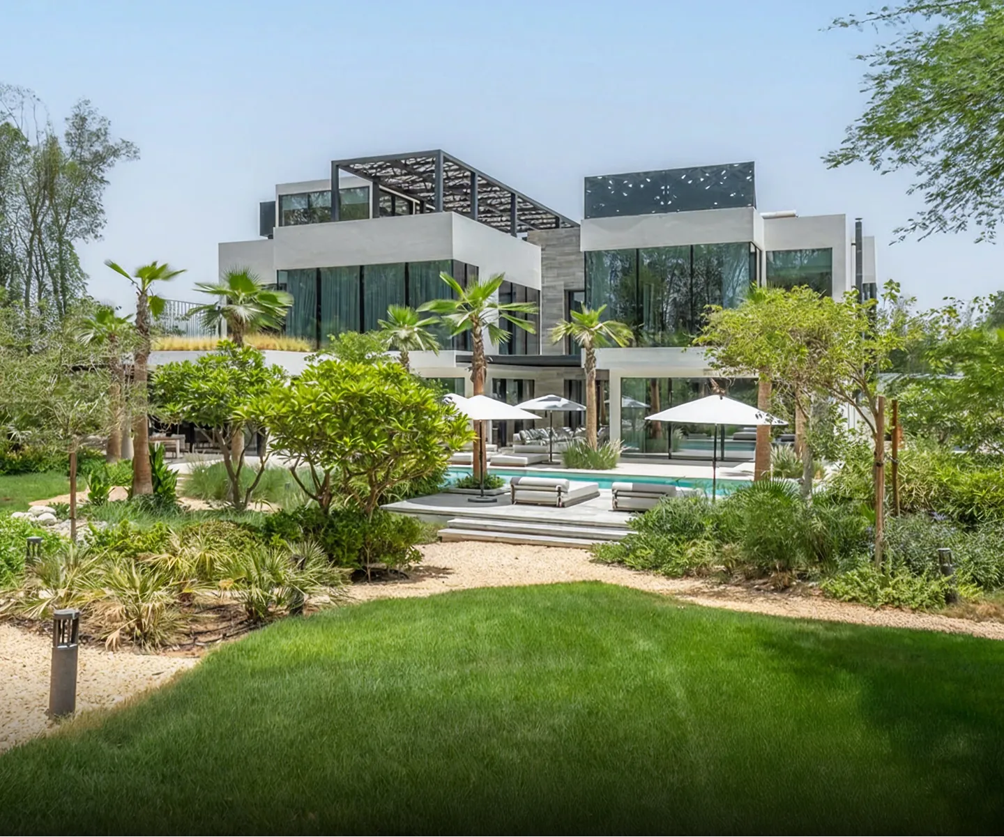 Modern beachfront villa with expansive windows in Abu Dhabi.