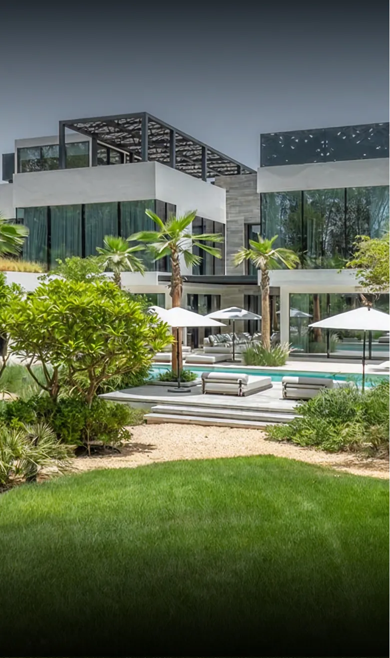 Modern beachfront villa with expansive windows in Abu Dhabi.