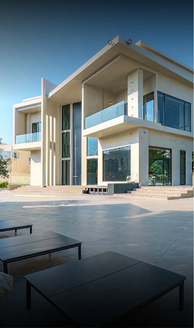 Modern beachfront villa with expansive windows in Abu Dhabi.