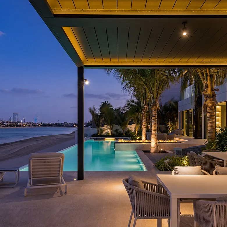 Outdoor space in a modern villa featuring a built-in pool and pergola in Dubai.