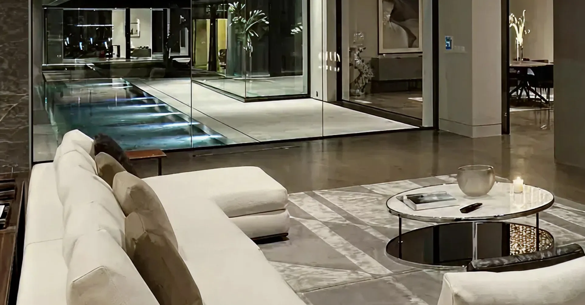 Contemporary villa design featuring a marble table and floor-to-ceiling windows in Dubai.