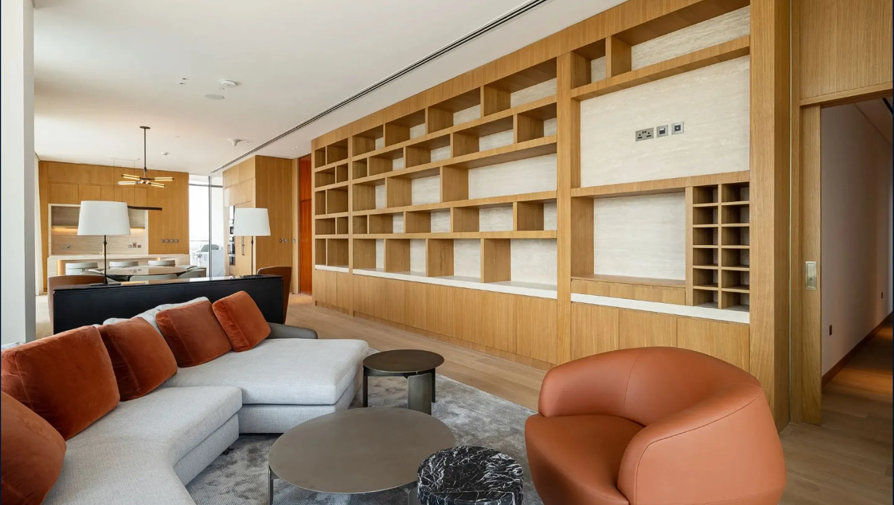 Modern Apartment Interior Design with wooden shelving and custom seating by Rayfitout.