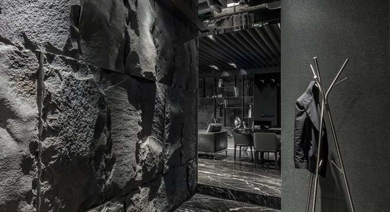 Contemporary Apartment Interior Design with dark stone wall and dining area.