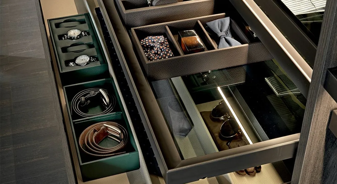 Modern luxury wardrobe with accessories on display in open drawers.
