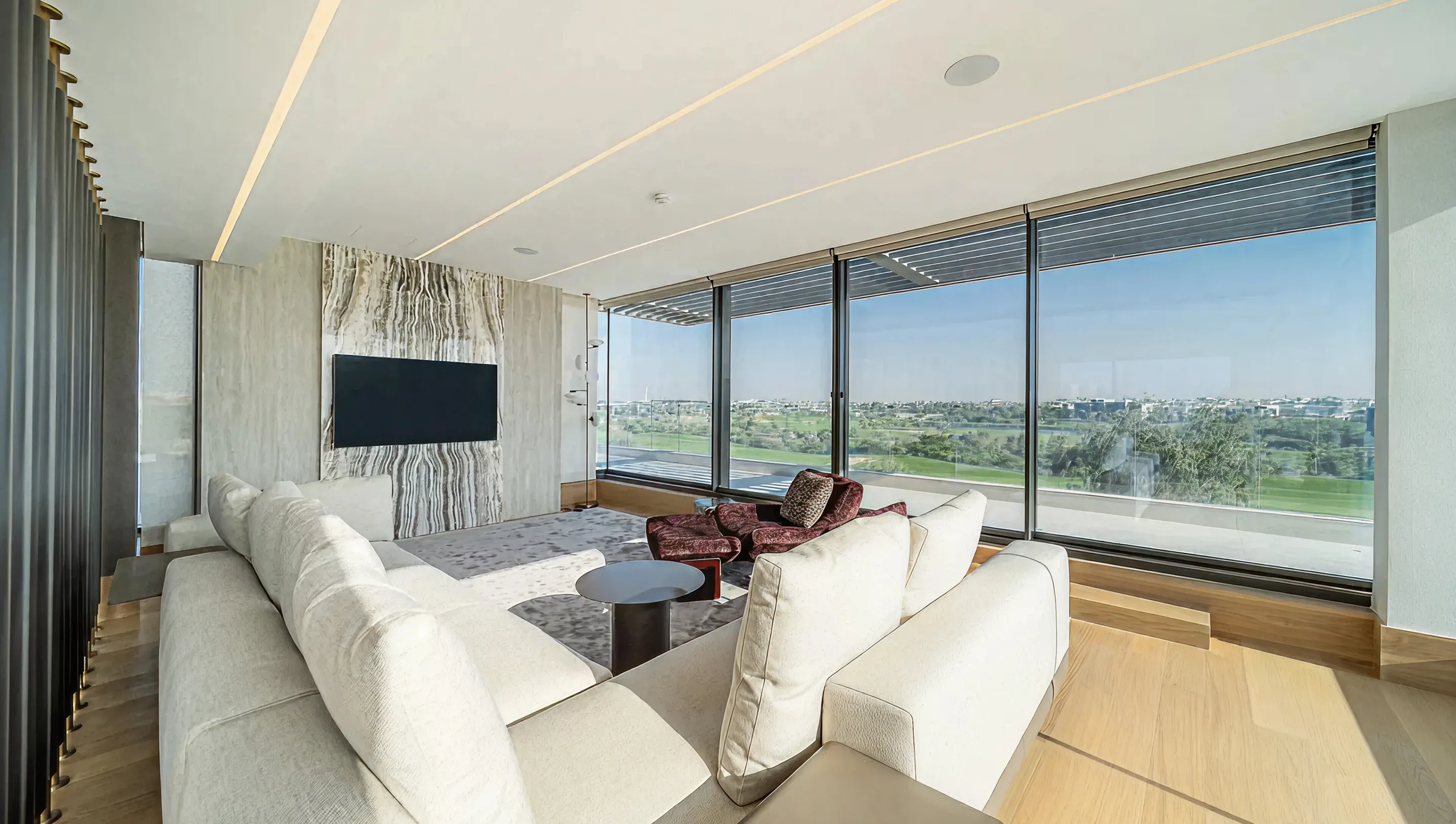 Residential interior design of a modern luxury living room with expansive windows.