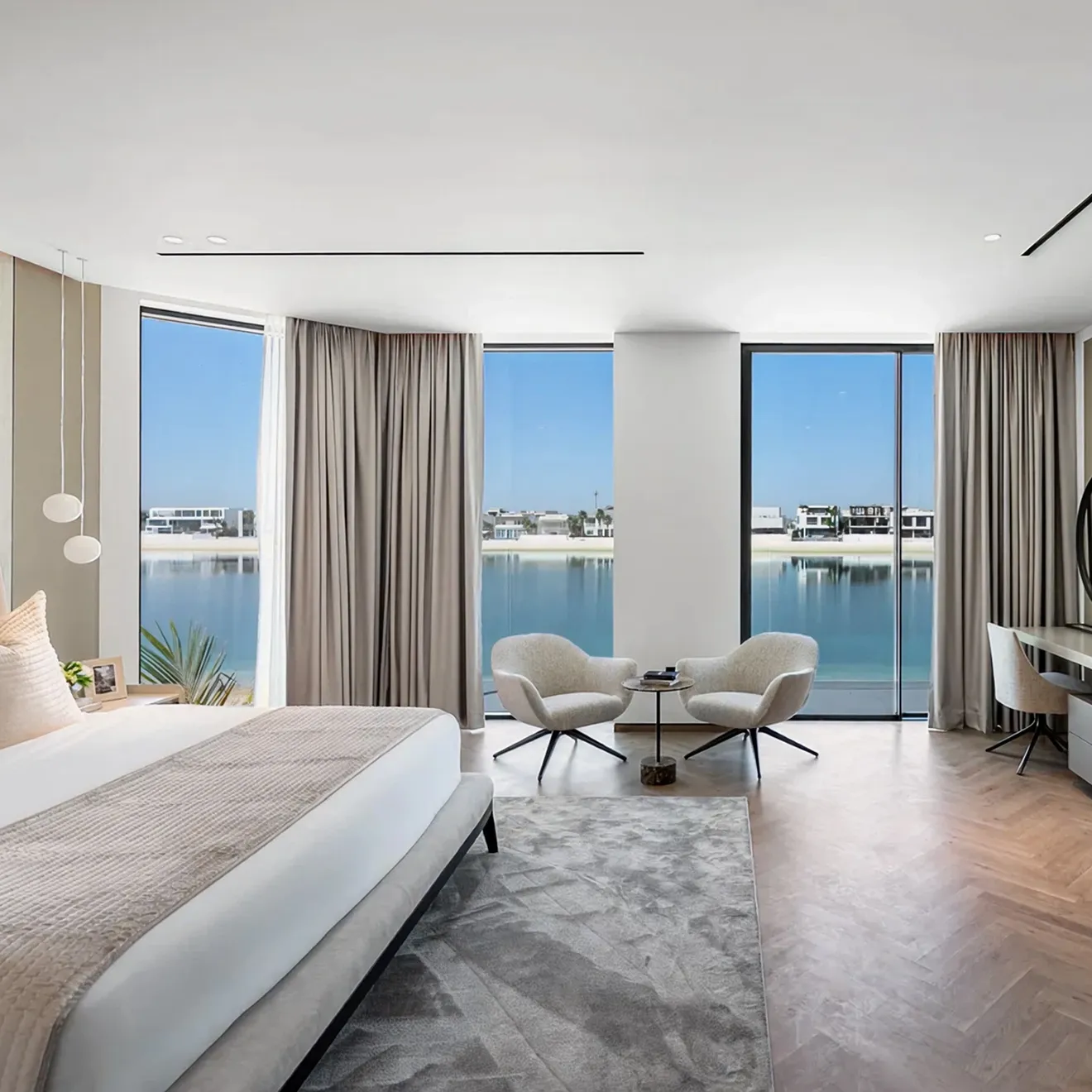 Luxury bedroom interior featuring modular seating and expansive windows in Dubai.