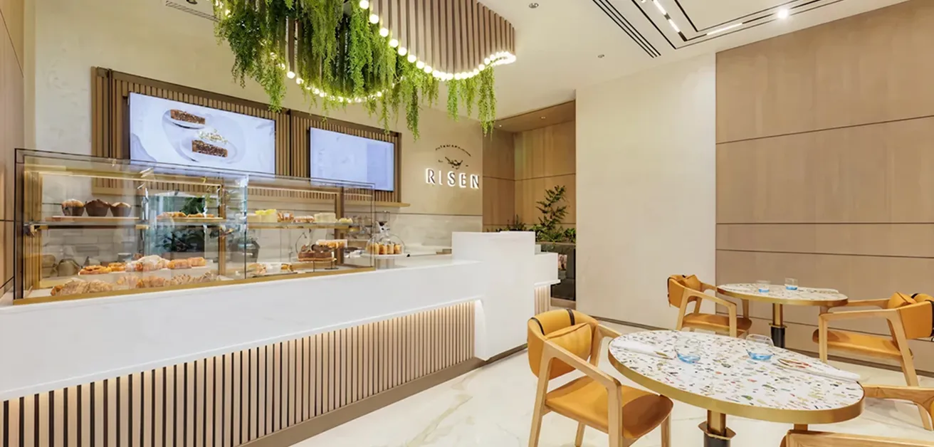 Modern cafe interior design with quality materials and greenery.