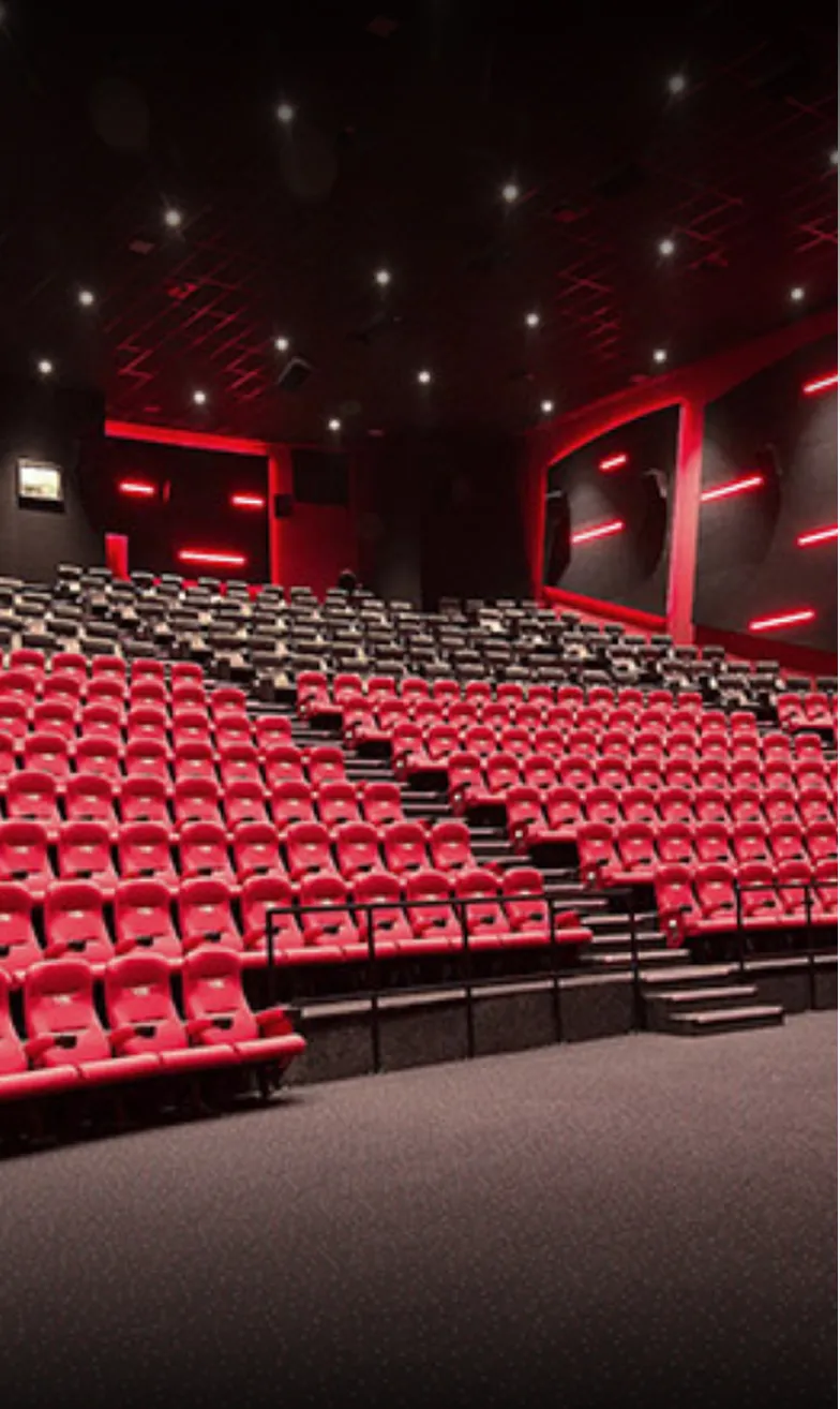 Commercial Interior Design of a modern cinema auditorium with red accent lighting by Rayfitout.