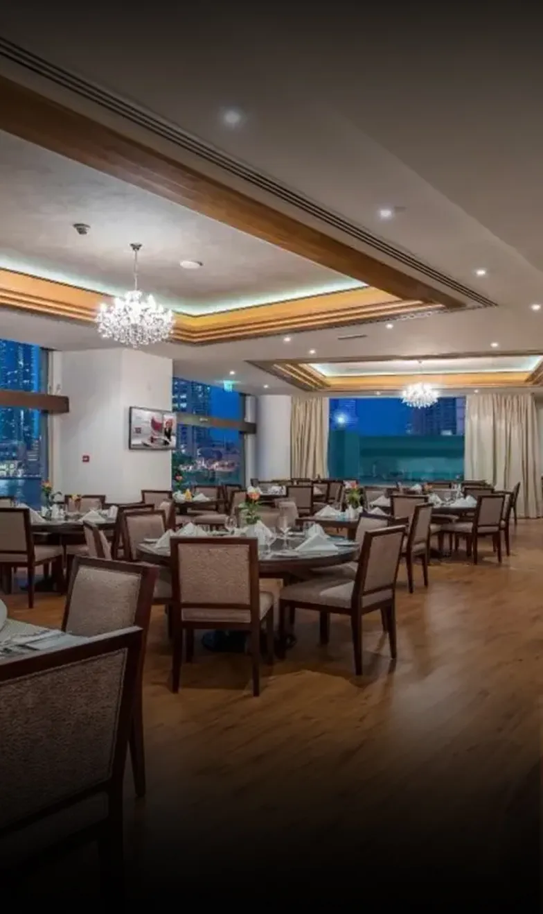 City Premiere Hotel interior featuring buffet station, chandeliers, and wood accents in Dubai.