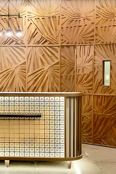 Luxury lobby interior featuring modern lighting and textured wooden panels.