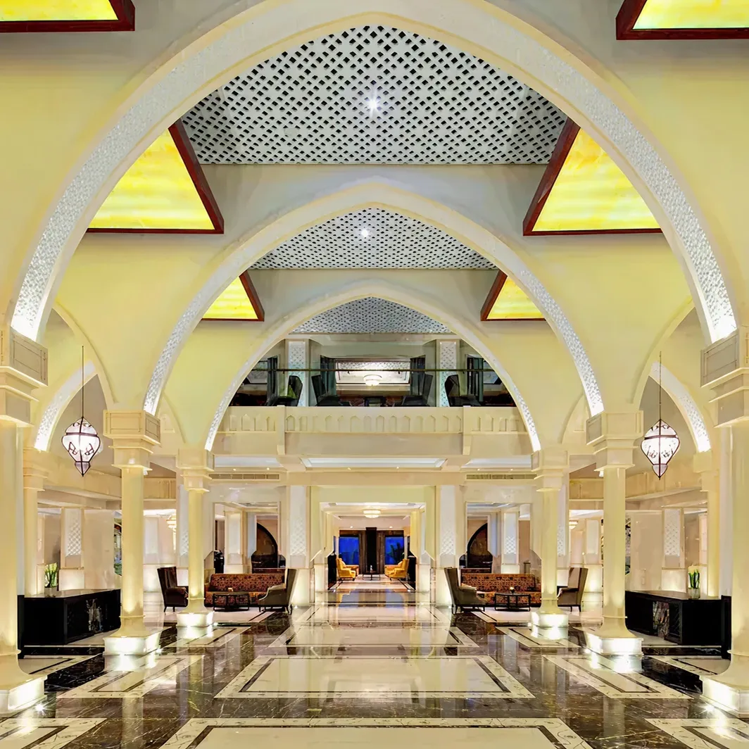 Luxury hotel lobby interior with Middle Eastern arches and marble floors in Dubai.