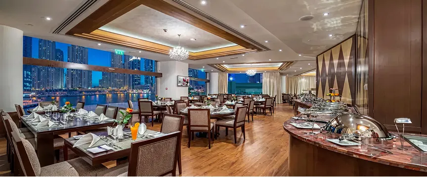 Luxury hospitality interior design featuring floor-to-ceiling windows and city views.