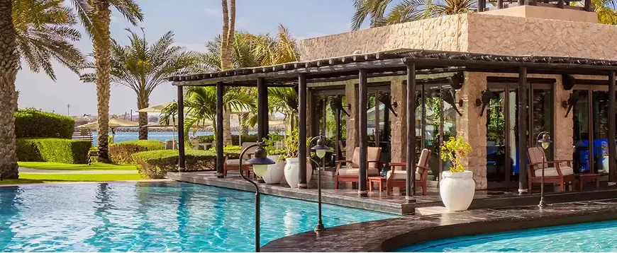 Resort hospitality interior design featuring poolside dining in Dubai.