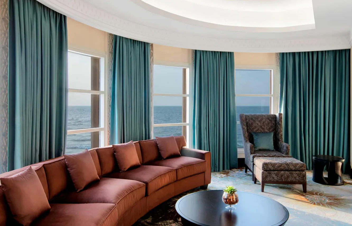 Contemporary hospitality interior design featuring floor-to-ceiling windows and modular sofas.