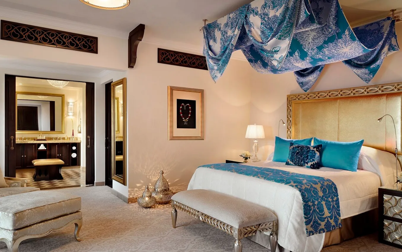 Bedroom interior design in Dubai featuring Arabian furnishings and marble bathroom interiors.