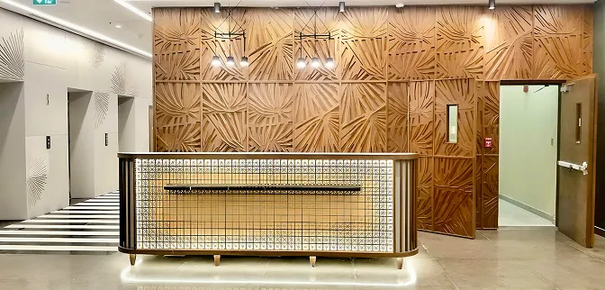 Luxury lobby interior featuring modern lighting and textured wooden panels.