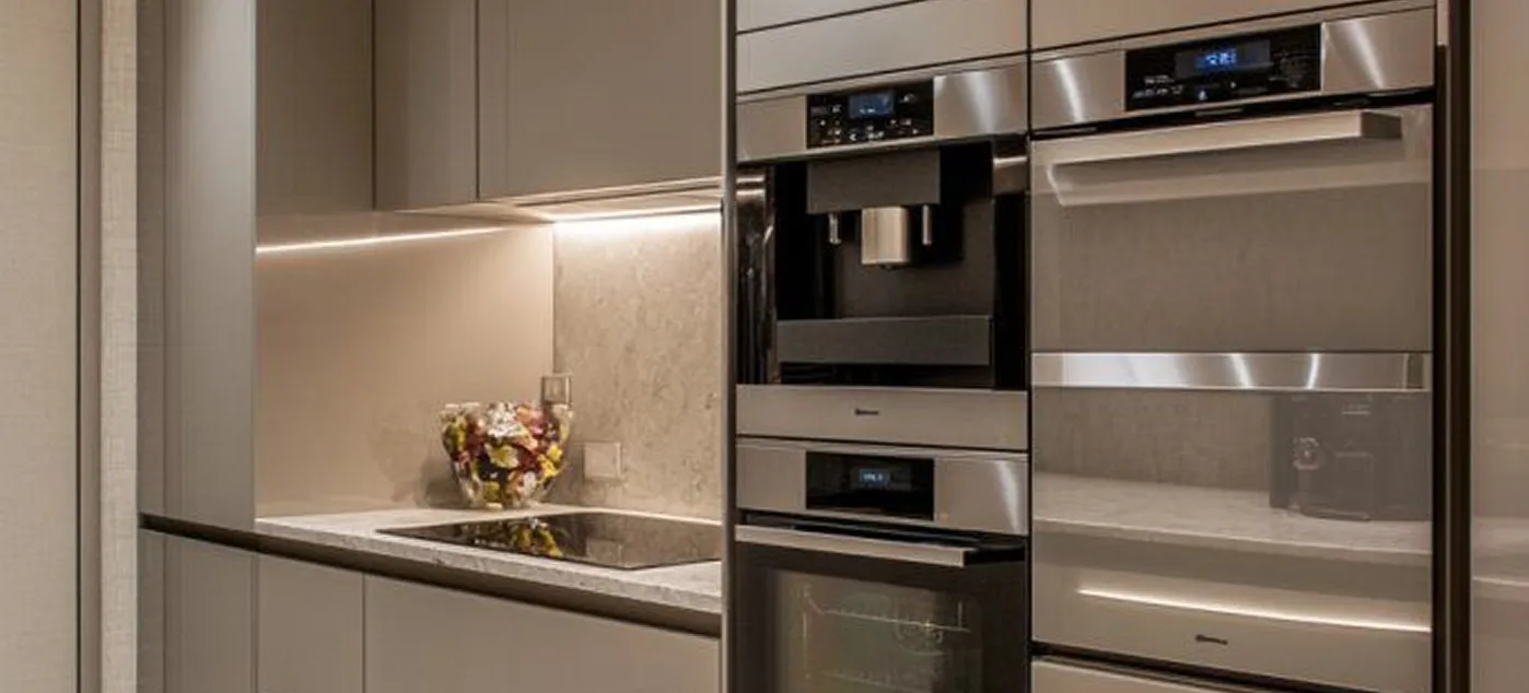 Luxury kitchen interior design with built-in stainless steel appliances and handleless cabinetry.