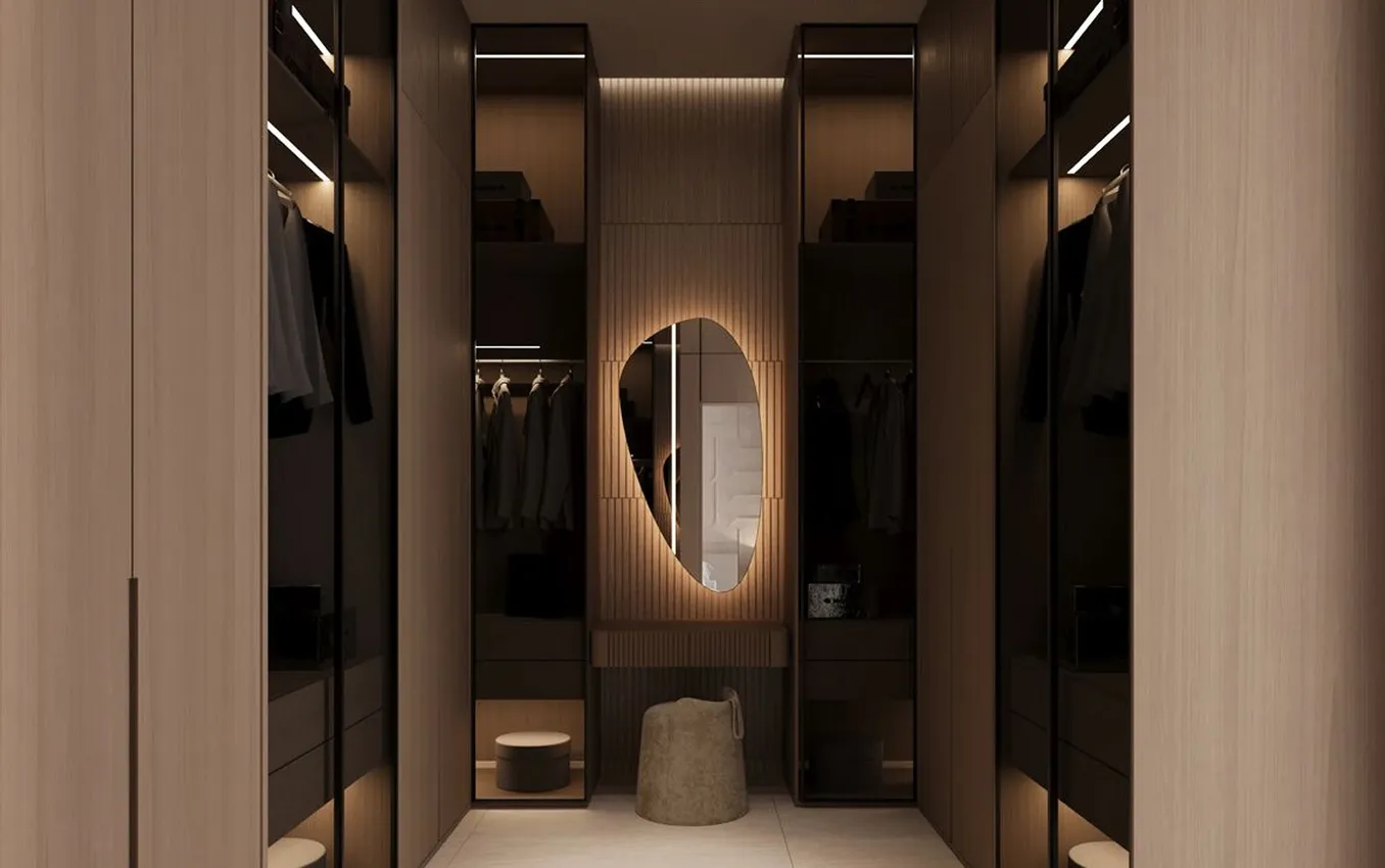 Modern wardrobe featuring a custom illuminated mirror and drawers in a luxury villa.